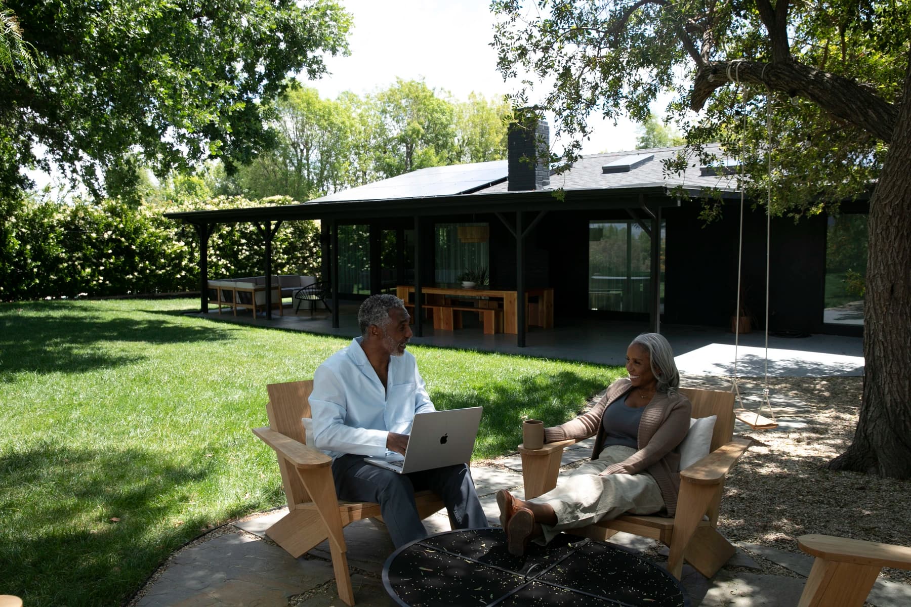 Couple in backyard with house in background