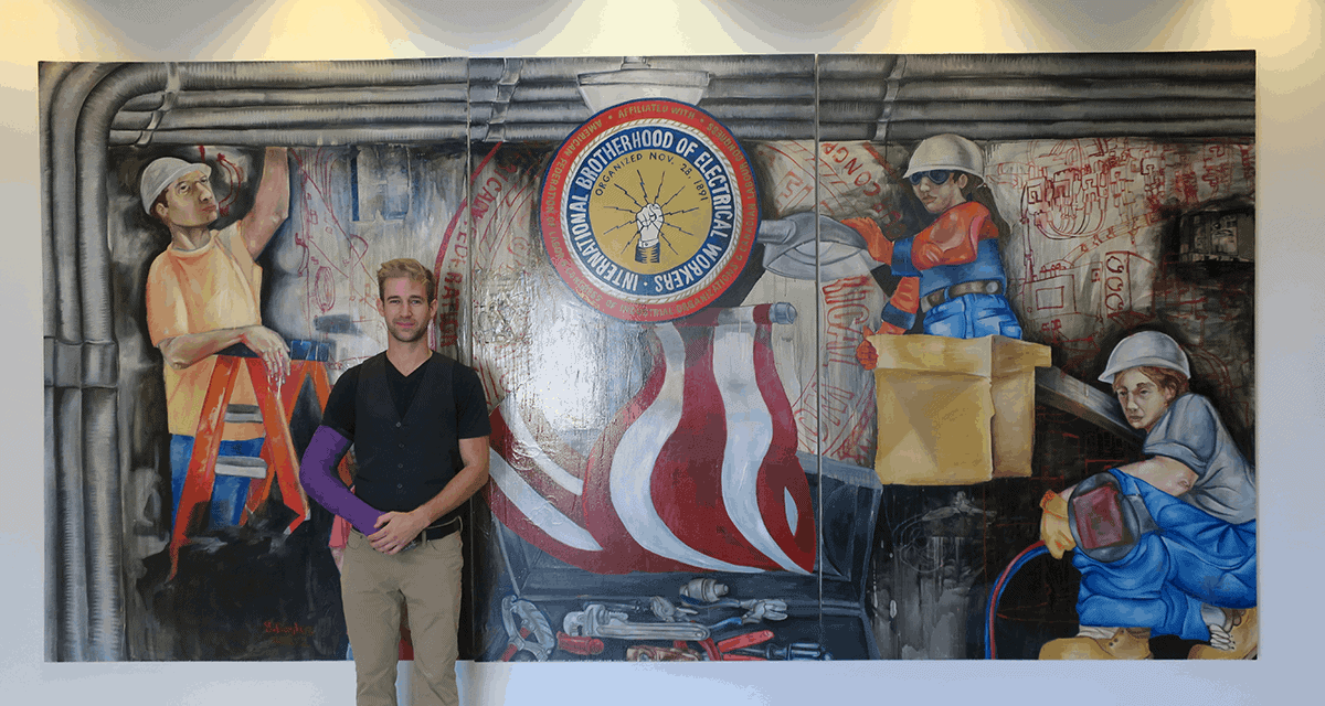 Alternative Energy Engineer Christopher Smith in front of IBEW mural