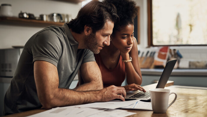 Couple with a laptop doing finance paperwork